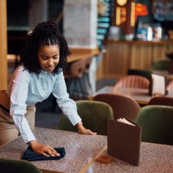 happy-african-american-waitress-cleaning-tables-in-a-cafe-.jpg